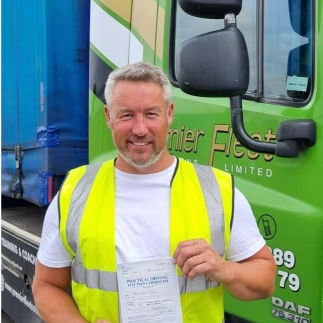 Man holding pass cerificate for HGV Driver Training Category C+E with PFS Training