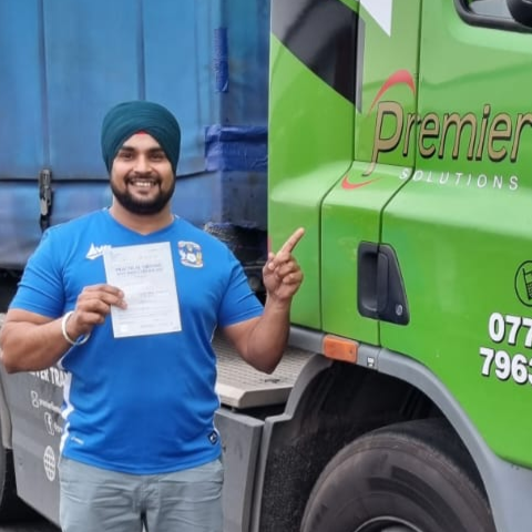 Man holding pass cerificate for HGV Driver Training Category C+E with PFS Training